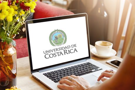 Imagen de una persona trabajando en una computadora con el logo de la UCR.